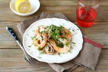 Buckwheat noodles with shrimp and cilantro on a white plate