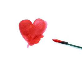 Painted red heart and a brush isolated over white