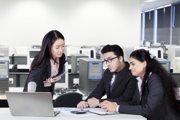 Chinese manager meeting with her team