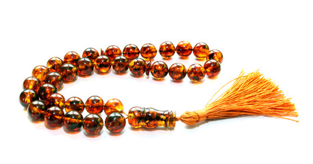 Baltic amber islamic rosary isolated on white © Irena Misevic