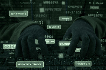 Closeup of hacker hands typing on keyboard