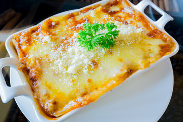 traditional lasagna made with minced beef bolognese sauce topped