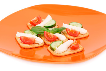 Crackers with fresh vegetables and cream
