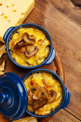 Moshroom casserole in a blue ceramic pot