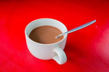 A cup of coffee on red table