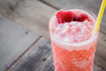 Strawberry Smoothie on wood table.
