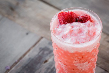 Strawberry Smoothie on wood table.