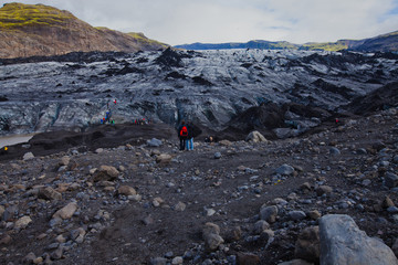 Iceland Glacier with a group of hikers hiking tourists climbing