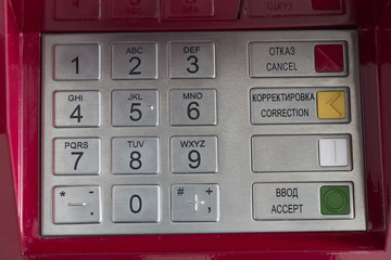 Metallic pinpad ATM on a red background