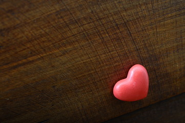 Red heart on wooden background