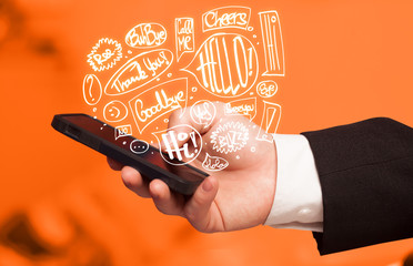Hand holding phone with hand drawn speech bubbles