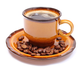 Heap of coffee grains and cup of beverage