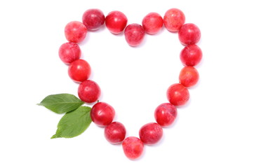 Heart of red mirabelle on white background