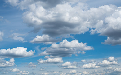 Cloudscape. The blue sky with white-grey clouds