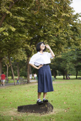 Girl standing on log.