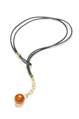 Orange round amber charm isolated on the white background