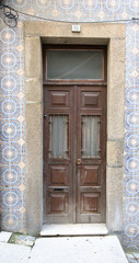 Fototapeta na wymiar Old wooden door with window on the wall with ceramic tile