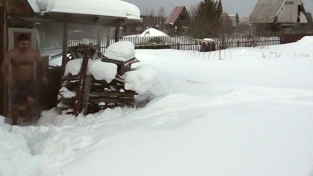 Russian sauna. Young man bathing in the snow