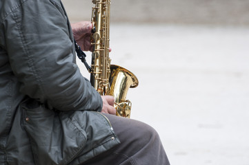 Street musician play the saxophone in the park