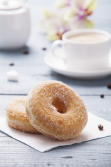 Fresh donut served with a cup of coffee