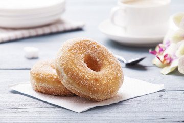 Fresh donut served with a cup of coffee
