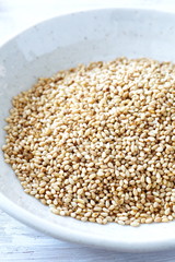 Organic natural sesame seeds on white wood table