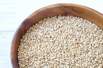 Organic natural sesame seeds on white wood table