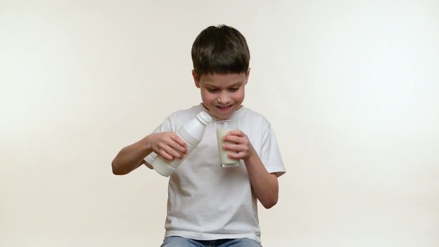 Boy drinking milk. White background