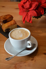 Hot cappuccino and small pizza on the table
