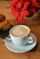 Hot cappuccino and small pizza on the table