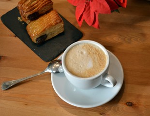 Hot cappuccino and small pizza on the table