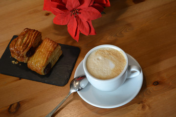 Hot cappuccino and small pizza on the table