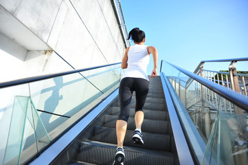 Runner athlete running on escalator stairs.    