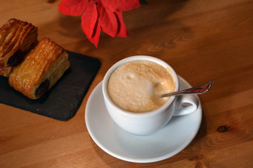 Hot cappuccino and small pizza on the table