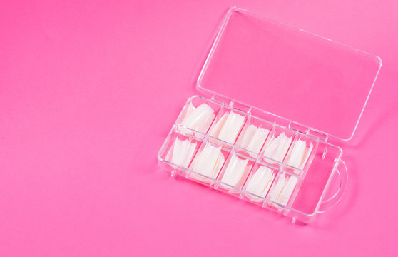 Fake nails in case on pink background