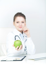 Woman Doctor Recommanding An Apple