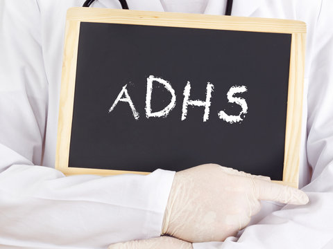 Doctor shows information on blackboard: adhs