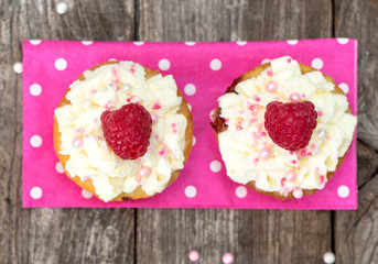 Couple of muffins with raspberries.
