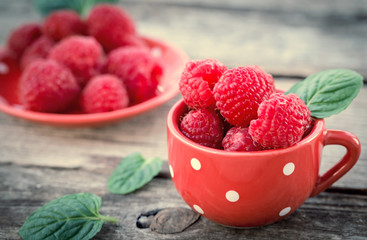 Raspberries in a cup with retro filter effect.  Close-up