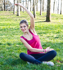 Pretty woman doing exercises in the park