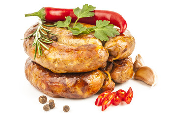 Two rings of smoked sausage with rosemary, pepper, and garlic is