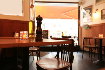 Interior of the cafe, tables, chairs and a large window