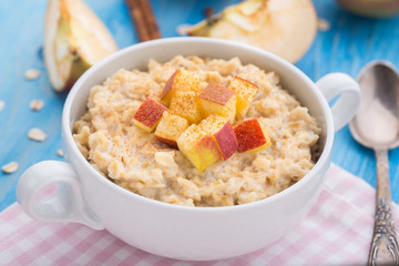 Tasty oatmeal with apples and cinnamon