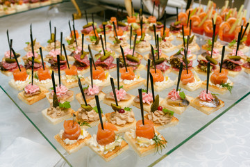 Catering - served table with various snacks, canape and appetize