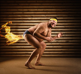 Very strange naked man farts by fire - obrazy, fototapety, plakaty
