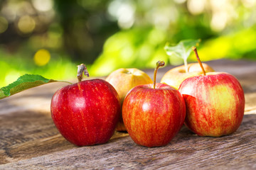 Ripe apples on wooden table, on nature background