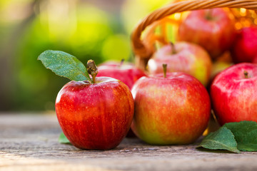 Ripe apples on wooden table, on nature background