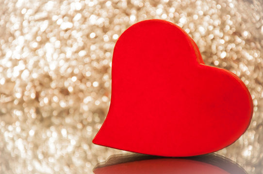 Red valentine heart on shiny background