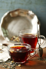 Beautiful vintage composition with herbal tea, on wooden table