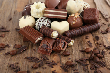 Delicious chocolate candies on wooden background
